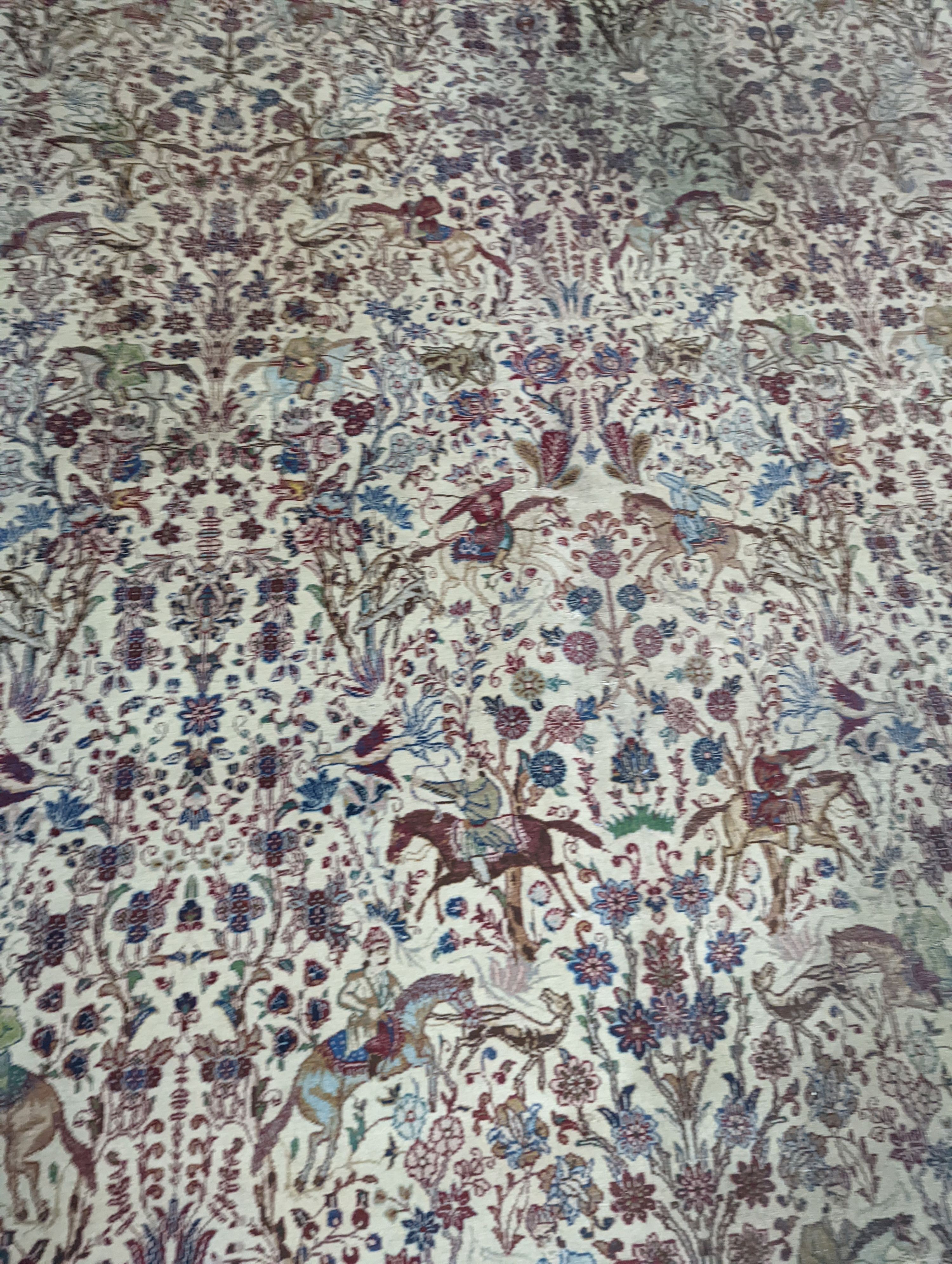 A Tabriz ivory ground pictorial rug (signed), 390 x 294cm